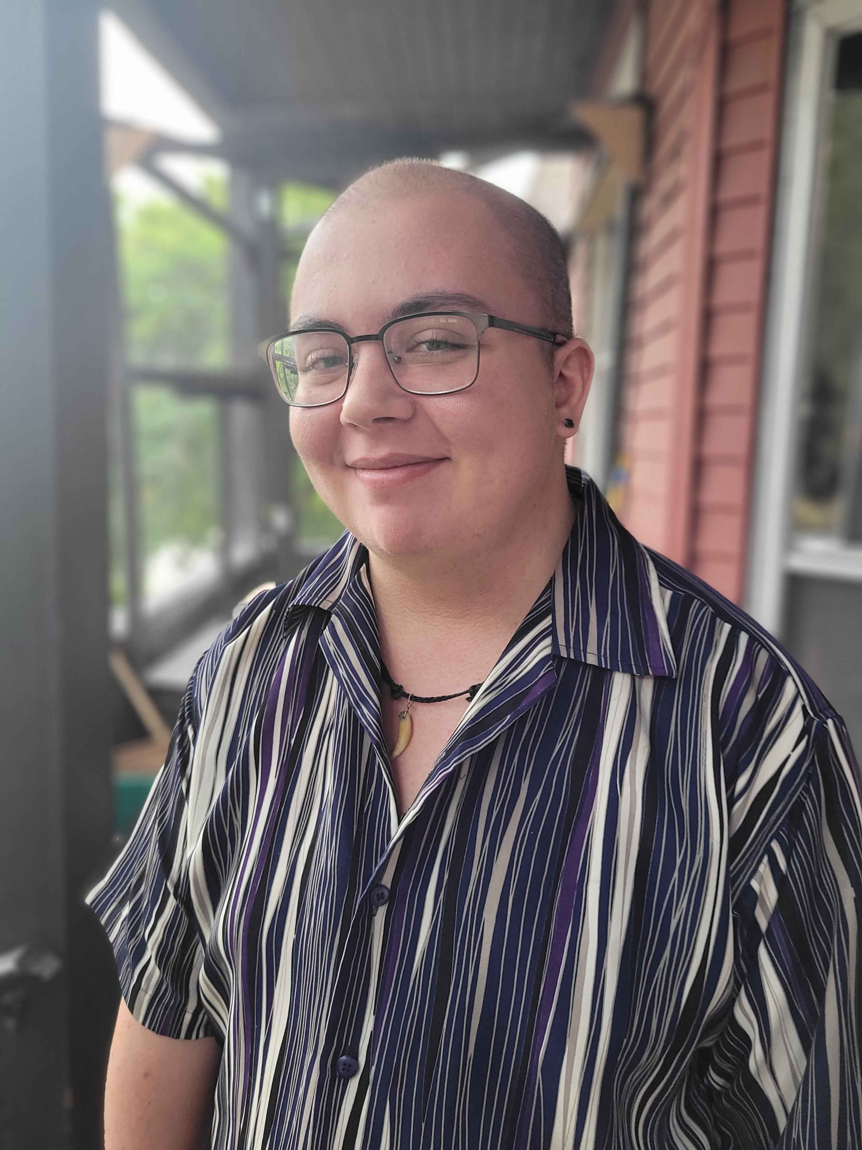 Headshot of author Silas Maxwell Switzer. He is wearing glasses and a striped shirt.