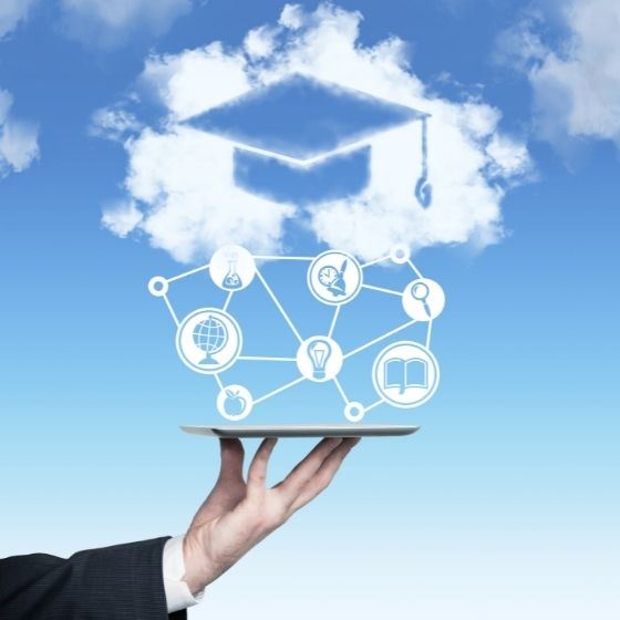 Hand holding platter of technology icons below a graduation cap outline in a cloud